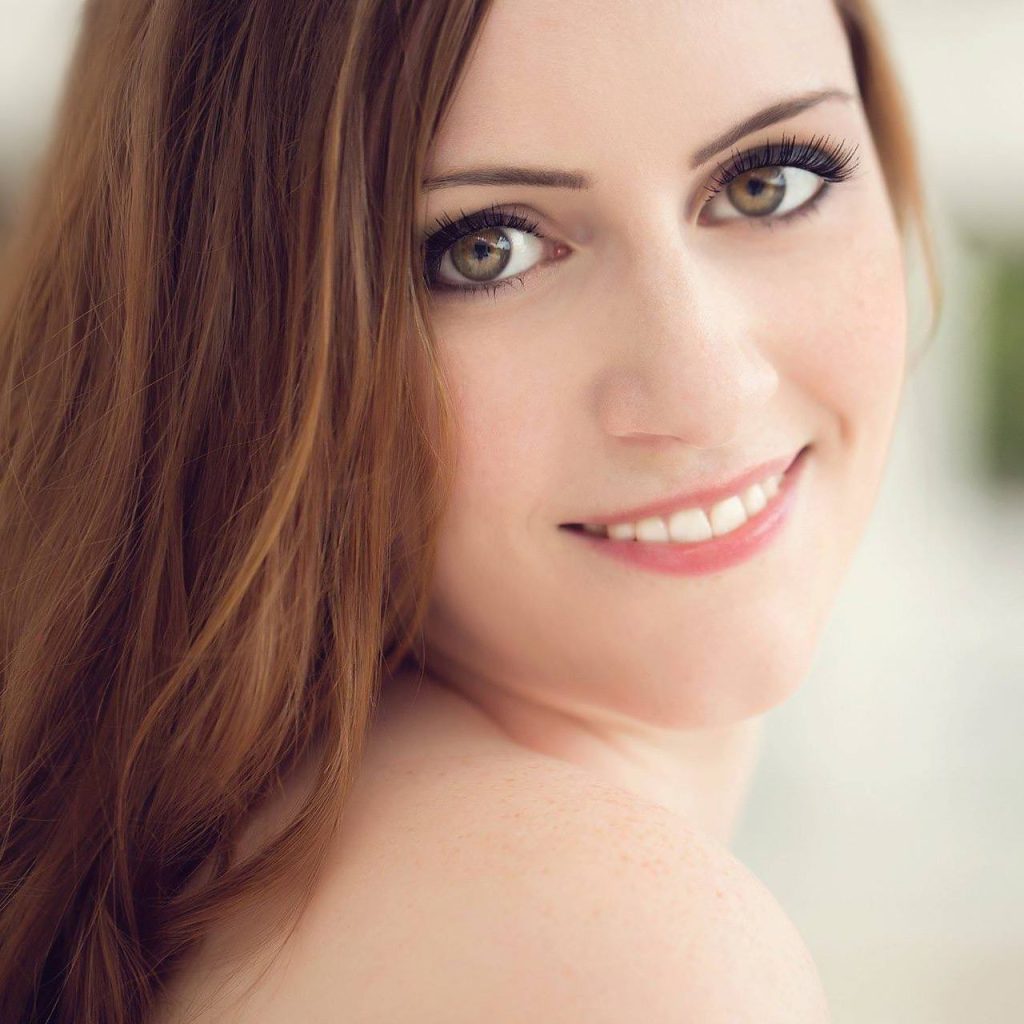 Monica is a female in her 30's with brunette hair, fair skin, and a friendly smile.