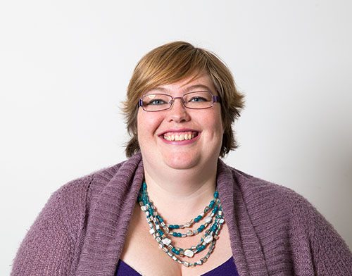 Gian Wild is a white plus-size woman with short blonde hair with a big smile
