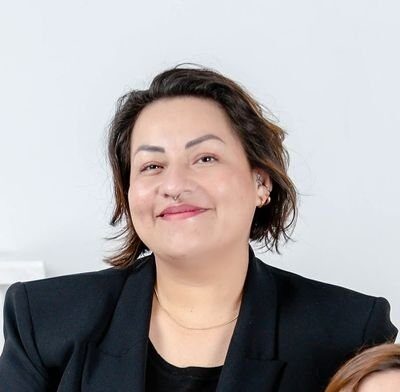 Merary is a Latina from Costa Rica with short hair and a big friendly smile.
