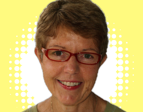 Tina Cook is a friendly female with a warm smile, short light brown hair, and wears glasses.