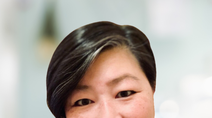 June Liu, Founder of backpocket ACE, wearing a dark shirt, with a friendly smile, and short hair.