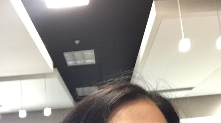 Asian woman with dark hair wearing glasses