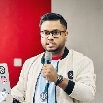Headshot of Nasim Miah, a web developer and SEO specialist, smiling in front of a neutral background.