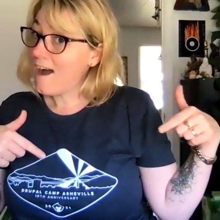 AmyJune is a white woman with blond hair and glasses wearing a Drupal Camp Asheville t-shirt