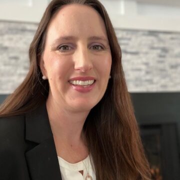 Abigail Silva is a white woman in her 40's with long brown hair and a friendly smile.