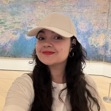 Paola Gonzalez is a latina woman in her 30s with long dark wavy hair.