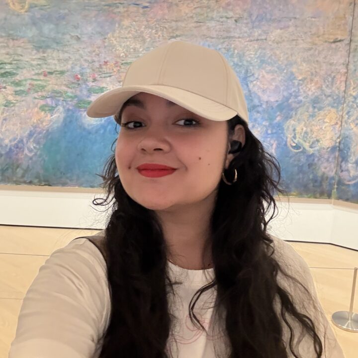 Paola Gonzalez is a latina woman in her 30s with long dark wavy hair.