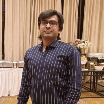 Dilip is an Indian man in his 30s with short black hair and a friendly smile. He is wearing a casual shirt and is facing the camera.